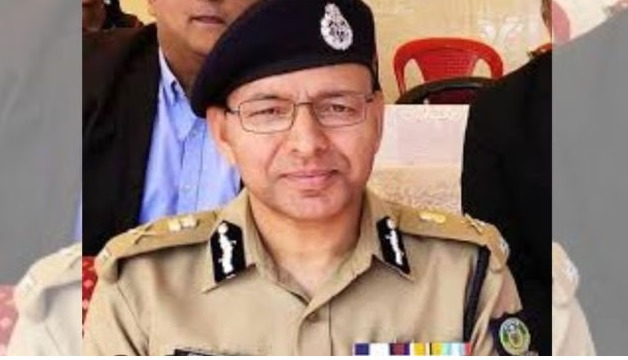 IPS officer Shyam Bhagat Negi in official uniform addressing media during a government event.